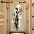 A framed abstract wall art print hangs in a hallway. The artwork depicts a stylized female silhouette in black, gray, white, and gold tones.