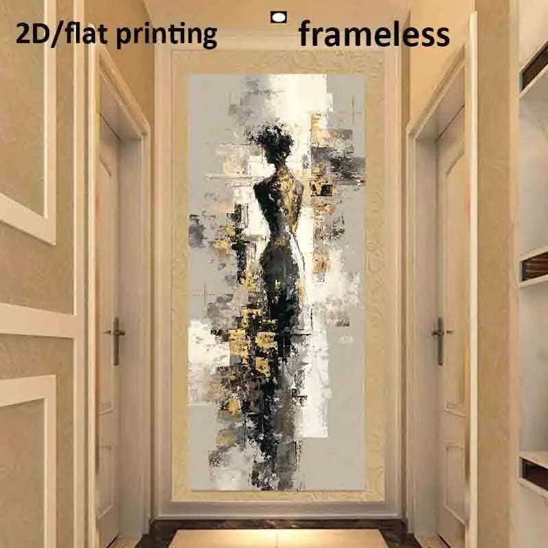A framed abstract wall art print hangs in a hallway. The artwork depicts a stylized female silhouette in black, gray, white, and gold tones.