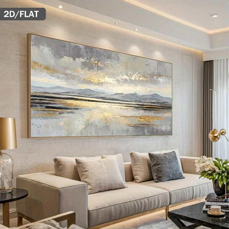 A large rectangular framed wall art piece with an abstract landscape design in gray, white, black, and gold tones, displayed above a beige sofa in a modern living room setting.