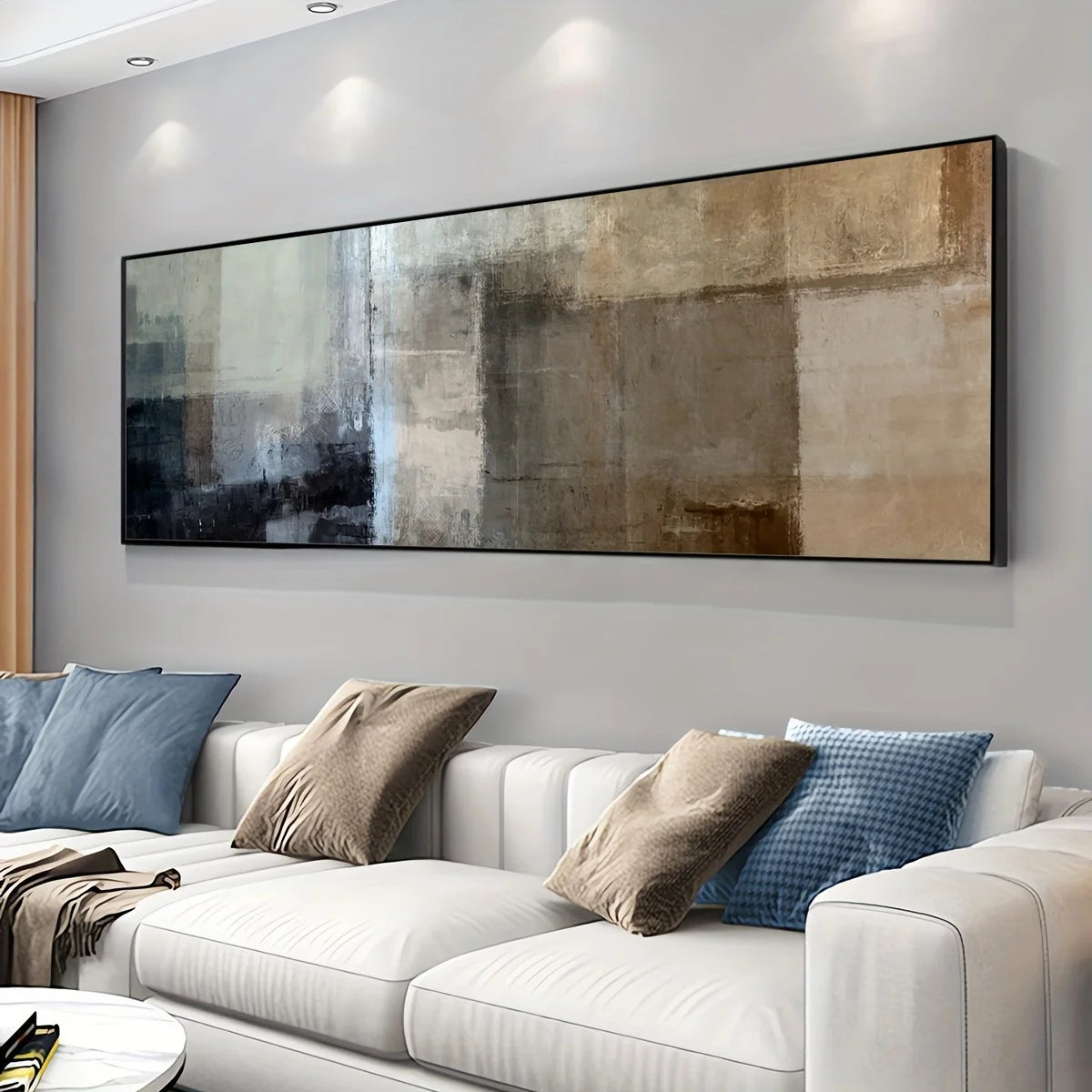 Modern living room with a white sofa and abstract wall art