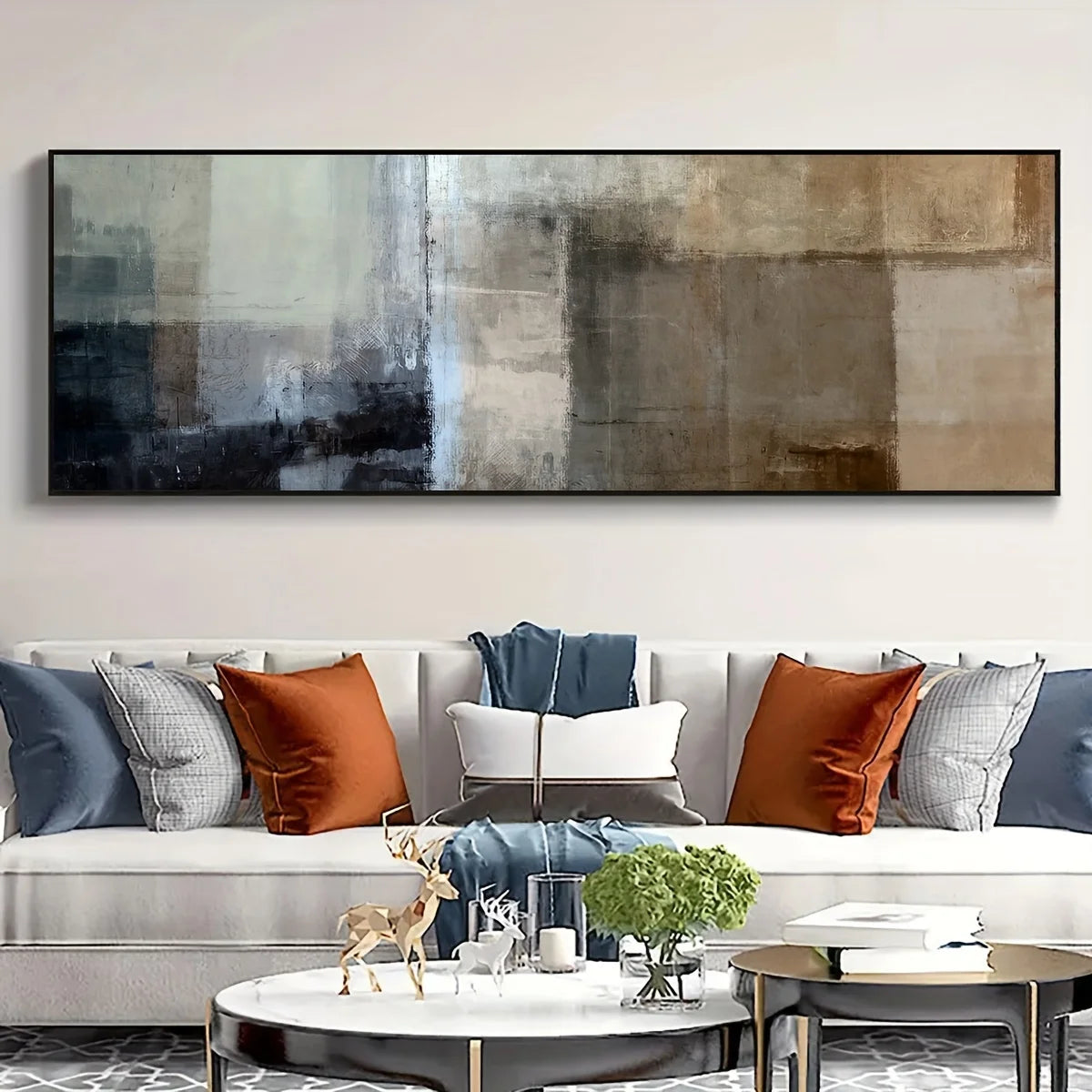 Living room with a long abstract painting above a sofa with colorful pillows.