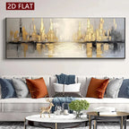 A wide rectangular abstract cityscape wall art piece in black, white, gray, and gold tones, displayed above a modern sofa in a styled living room. A red label in the top-left corner reads “2D FLAT.