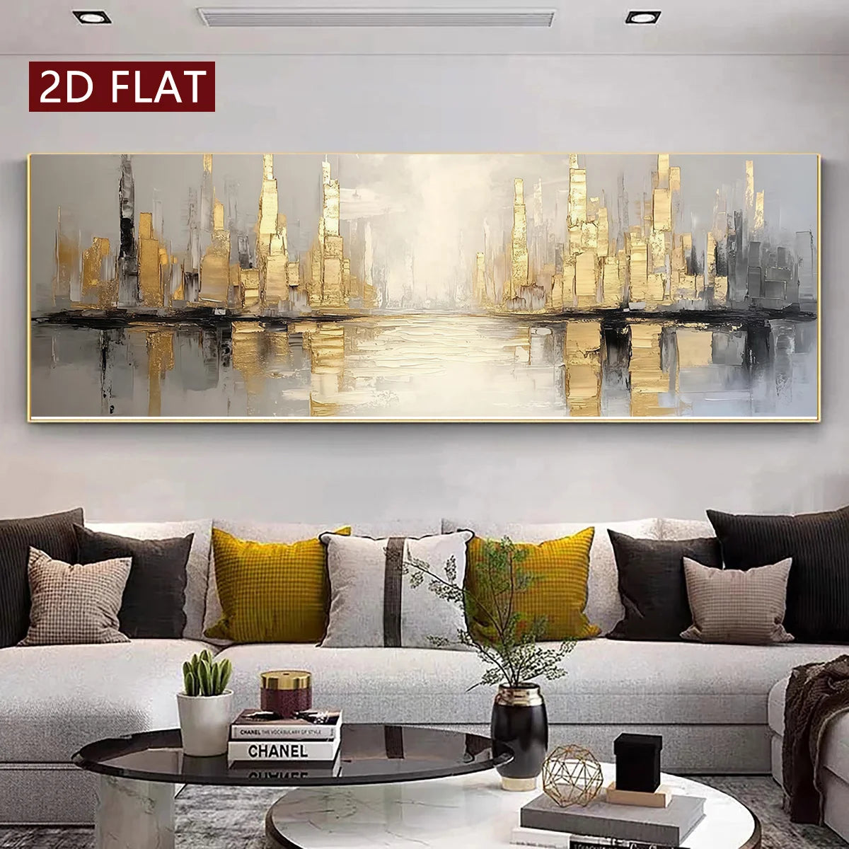 A large panoramic abstract canvas print of a city skyline with gold and gray buildings reflected in water, displayed on a light gray wall above a modern gray sofa with decorative pillows in a living room setting.