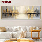 A large rectangular abstract cityscape wall art piece with gold, gray, black, and white tones, displayed above a white sofa in a styled living room. A red label in the top-left corner reads “2D FLAT.