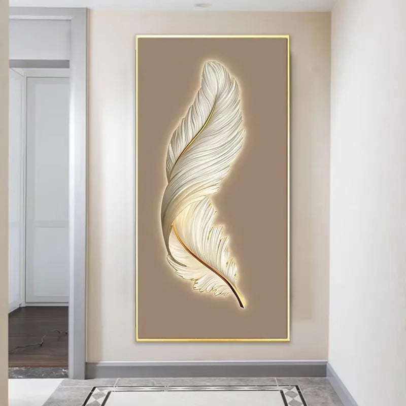 Decorative wall art of a feather with a gold frame on a beige wall.