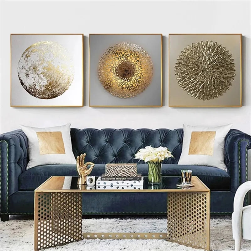 Modern living room with a blue sofa, gold coffee table, and decorative wall art.