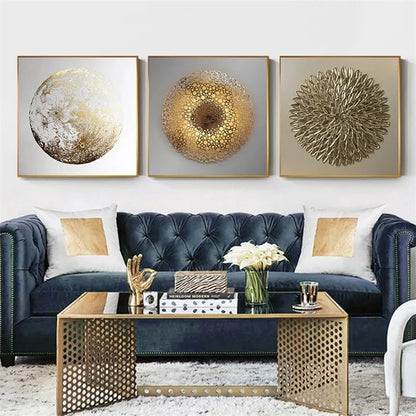 Modern living room with a blue sofa, gold coffee table, and decorative wall art.