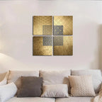Decorative wall art with gold and gray geometric patterns above a sofa.