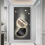 Modern wall art with abstract design and lighting fixture in a stylish interior setting.