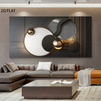 A large abstract wall art piece with black, white, gray, and metallic gold geometric shapes hangs above a modern sectional sofa in a styled living room. The artwork features bold circular and oval forms with metallic gold spheres and textured black-and-white patterned sections.