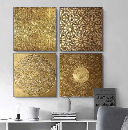 Four gold-colored wall art pieces with different patterns on a gray wall.