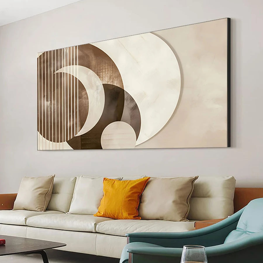 Abstract wall art above a sofa with decorative pillows in a living room setting.