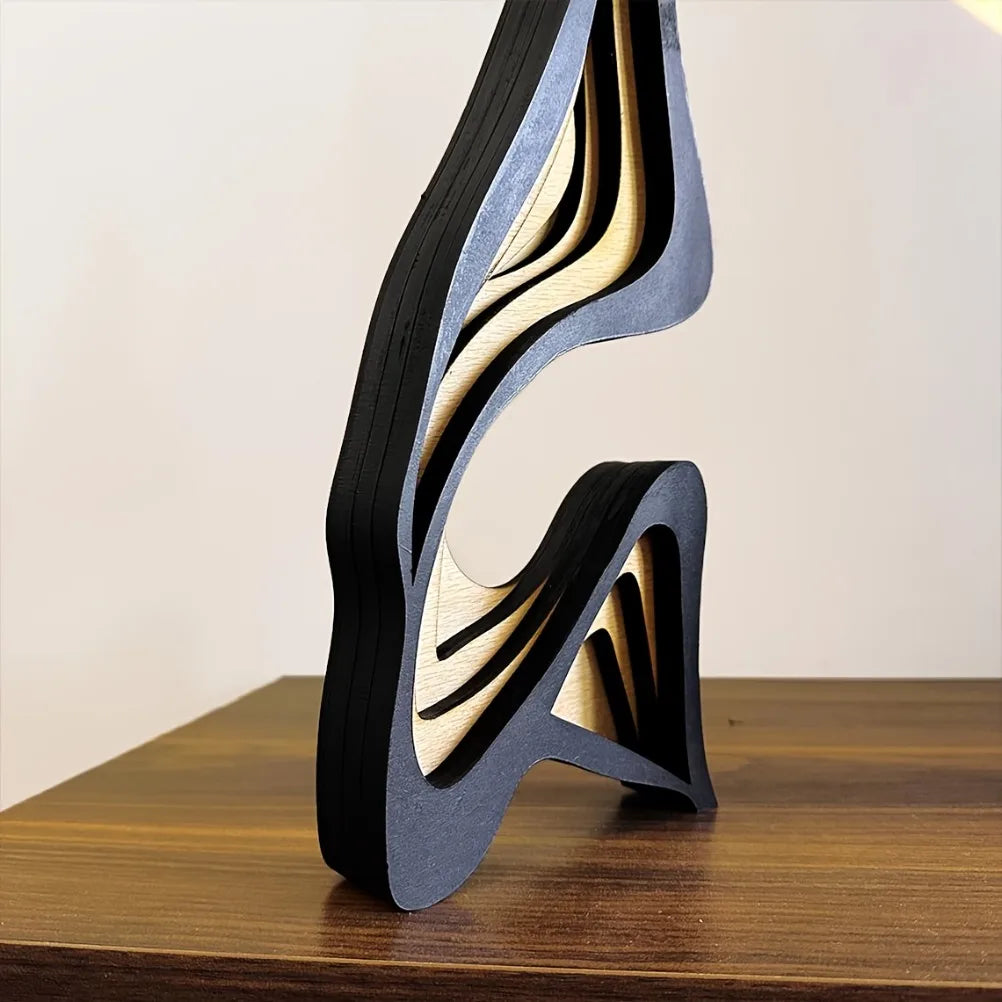 Sculptural object with wavy design on a wooden surface