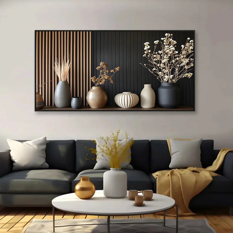 Living room with a black sofa, decorative vases, and a wall art piece.