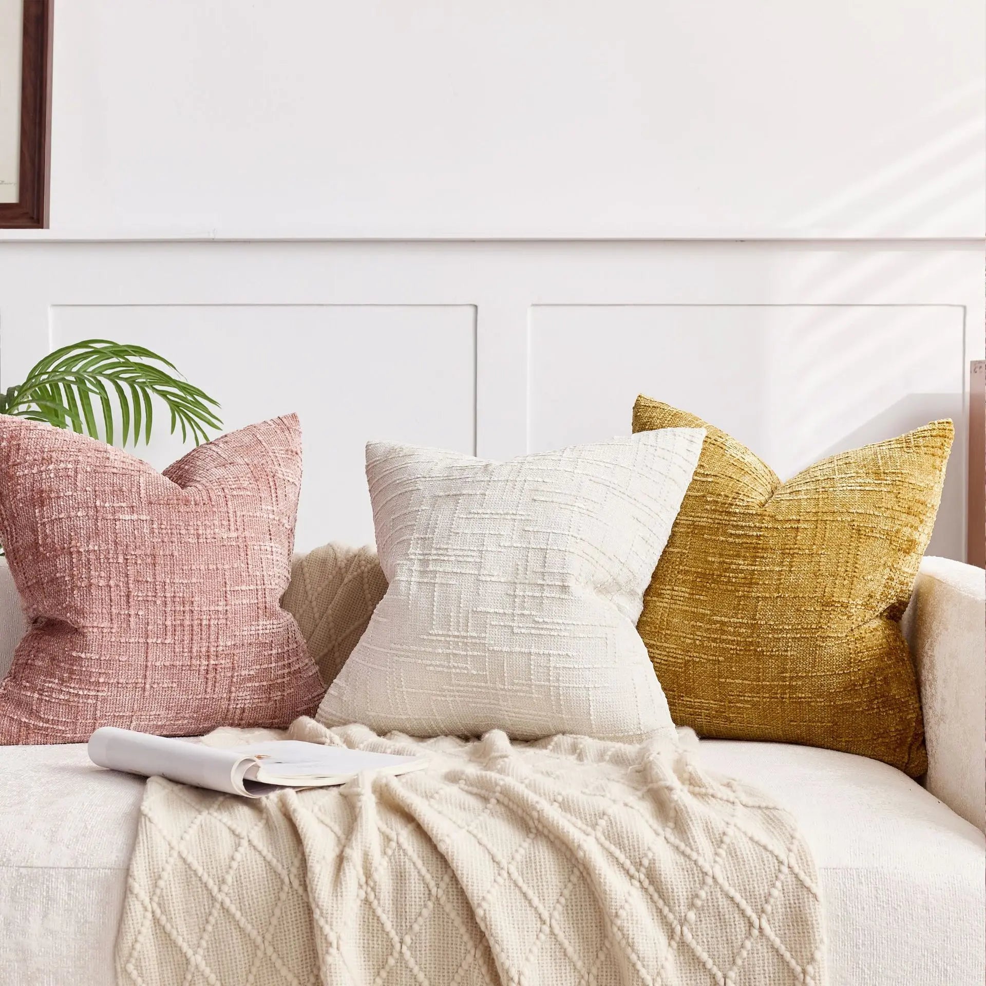 Decorative pillows on a bed with a neutral color scheme