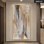 A large vertical abstract wall art piece with gold, beige, gray, and white brushstrokes, displayed in a modern hallway setting.