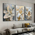 Three abstract floral paintings above a sofa in a living room.