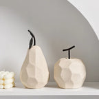 Two ceramic pear-shaped vases on a white surface with a neutral background