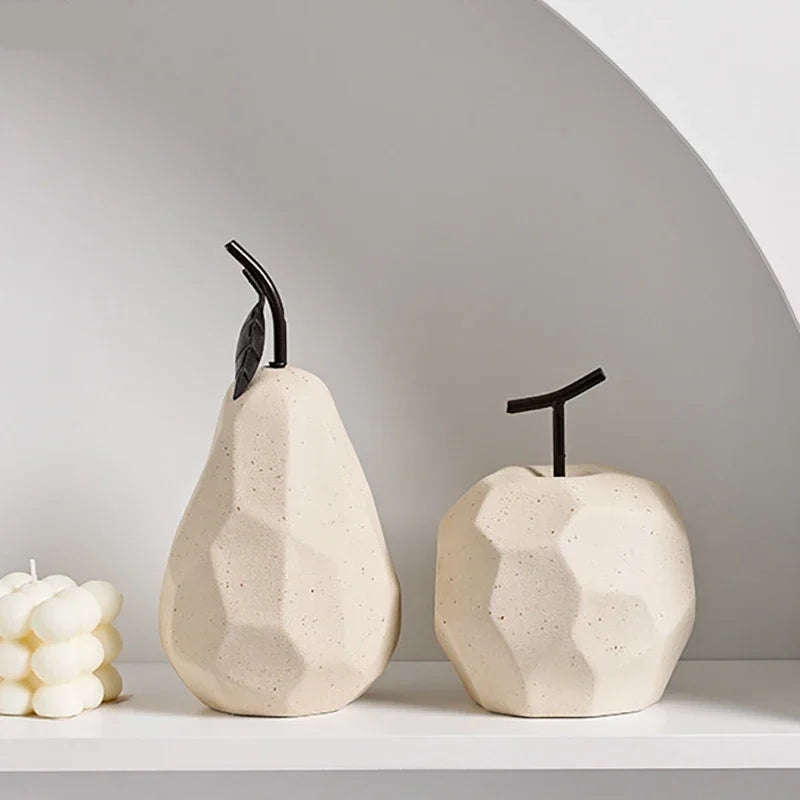Two ceramic pear-shaped vases on a white surface with a neutral background