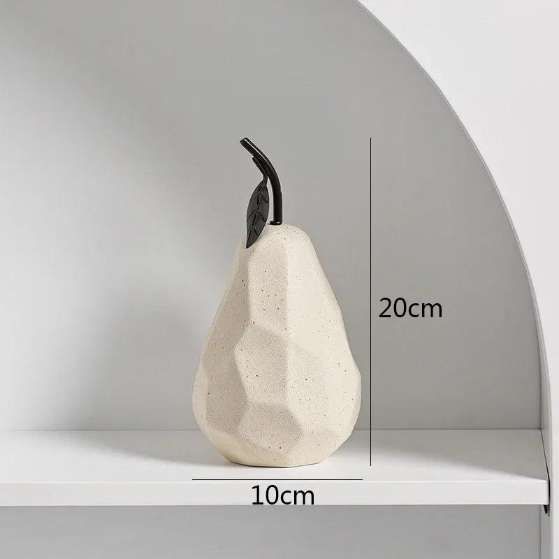 White ceramic pear-shaped object with black stem on a white surface, shown with measurements.