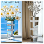Two vases with decorative ribbons, one holding flowers by a window and the other on a surface.
