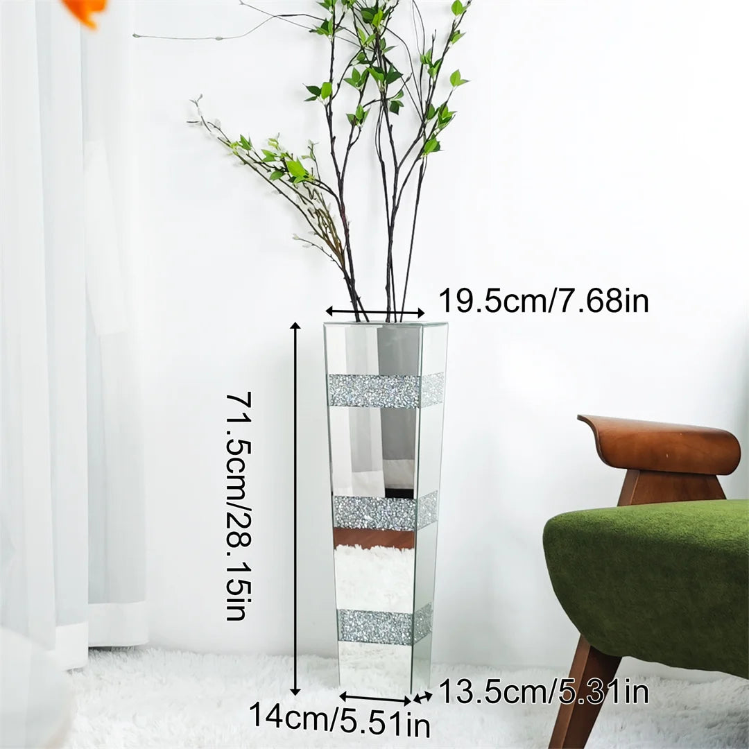 Glass vase with decorative patterns and measurements, placed indoors.