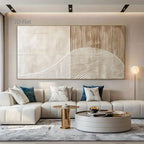 Modern living room with a large abstract painting on the wall, a beige sofa, and decorative items.