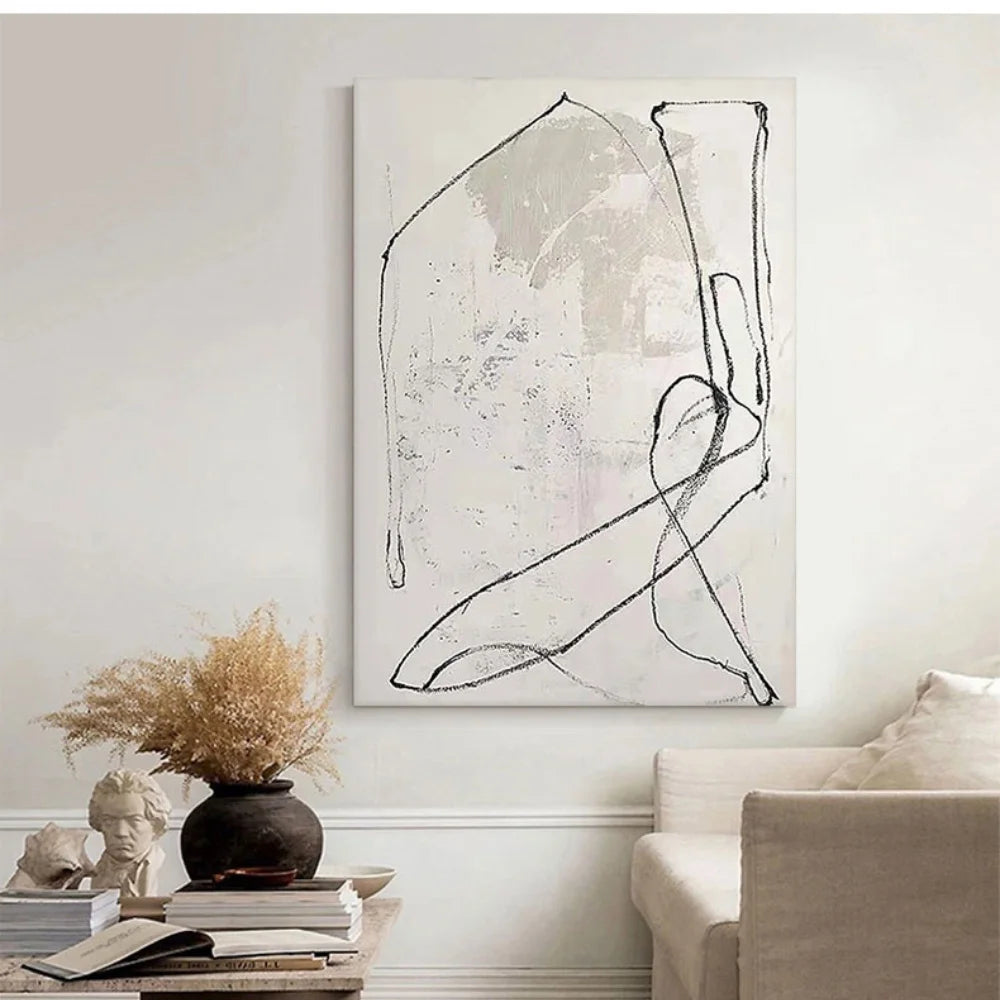 Abstract black and white painting on a wall in a living room setting.