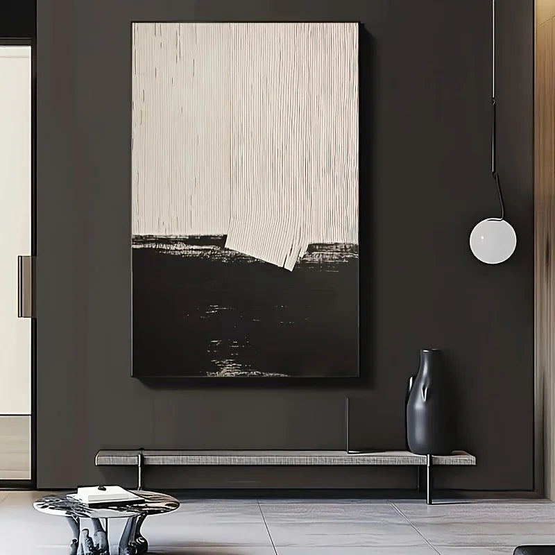 Abstract art piece on a dark wall with a vase and bench below.