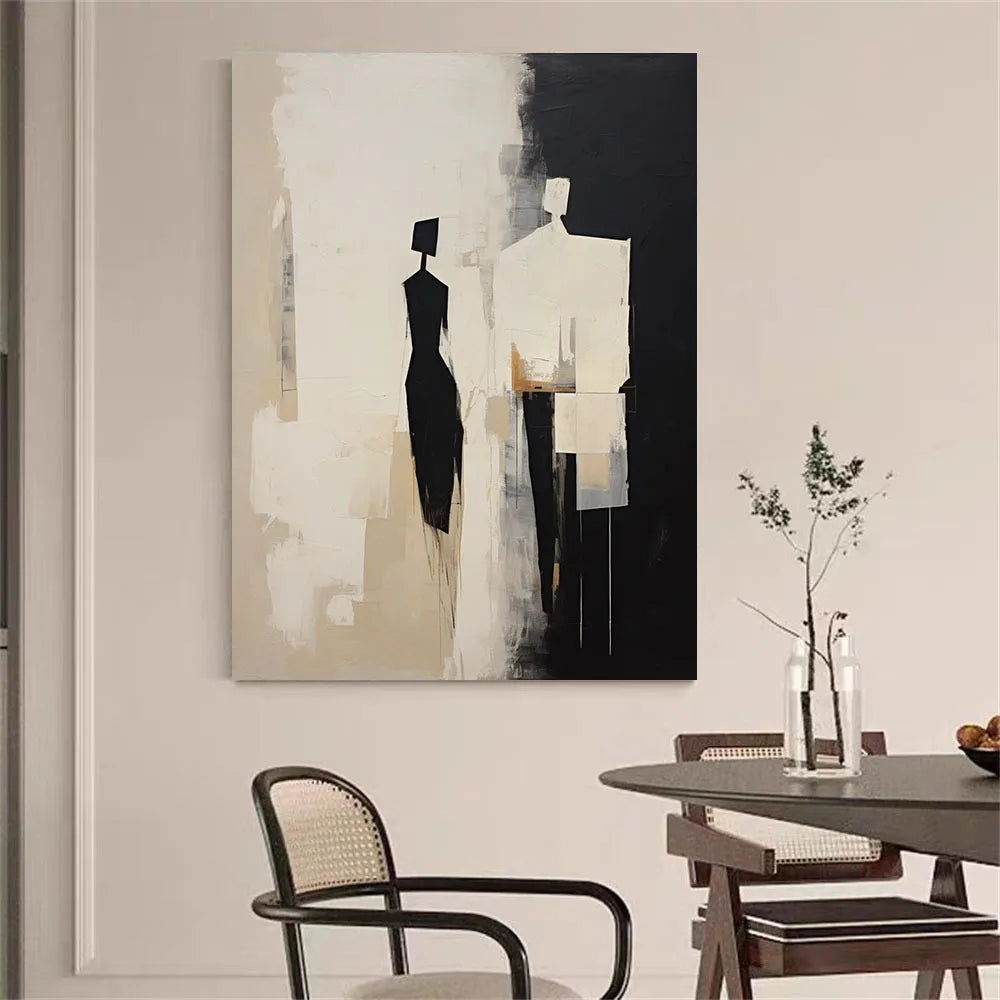 Abstract art piece on a wall above a dining table with chairs.