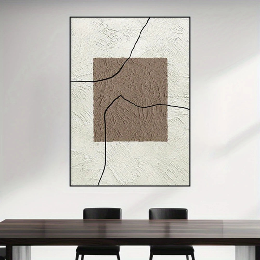 Abstract art piece on a wall above a table with chairs