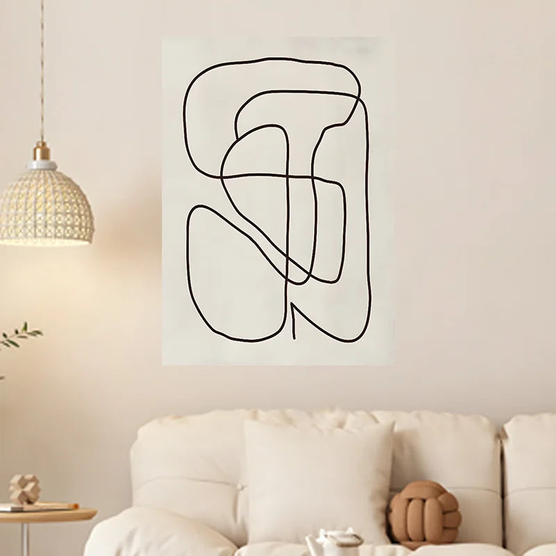 Abstract line art on a wall above a sofa in a living room