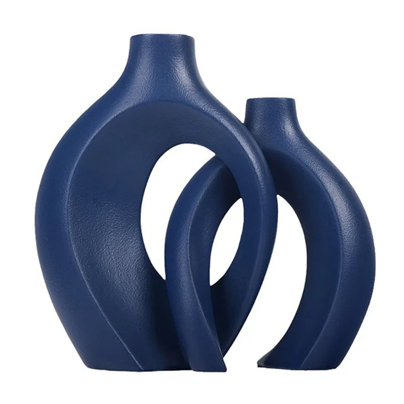 Two blue ceramic vases with a modern design on a white background