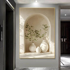 Decorative wall art of white vases and green plants in a neutral setting.