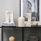 Decorative shelf with stone arches, books, and a framed black and white photo.