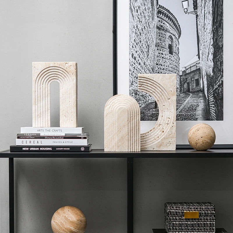 Decorative shelf with stone arches, books, and a framed black and white photo.