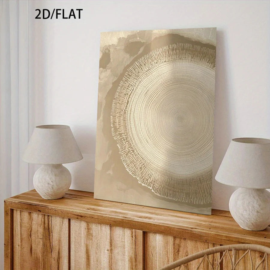A vertical abstract canvas print with a circular wood-grain pattern in beige and gold tones, styled on a wooden console table between two white table lamps against a white wall. 