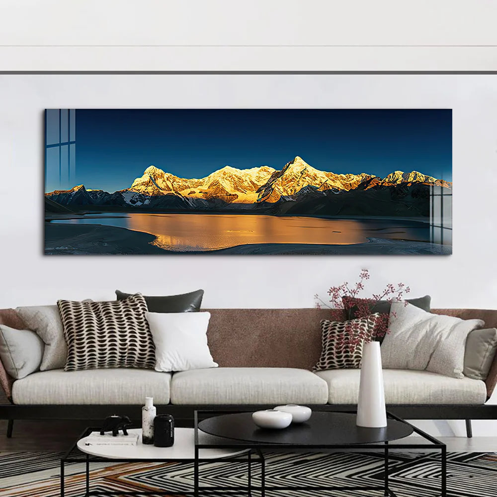 Panoramic mountain landscape painting above a living room sofa with decorative pillows.
