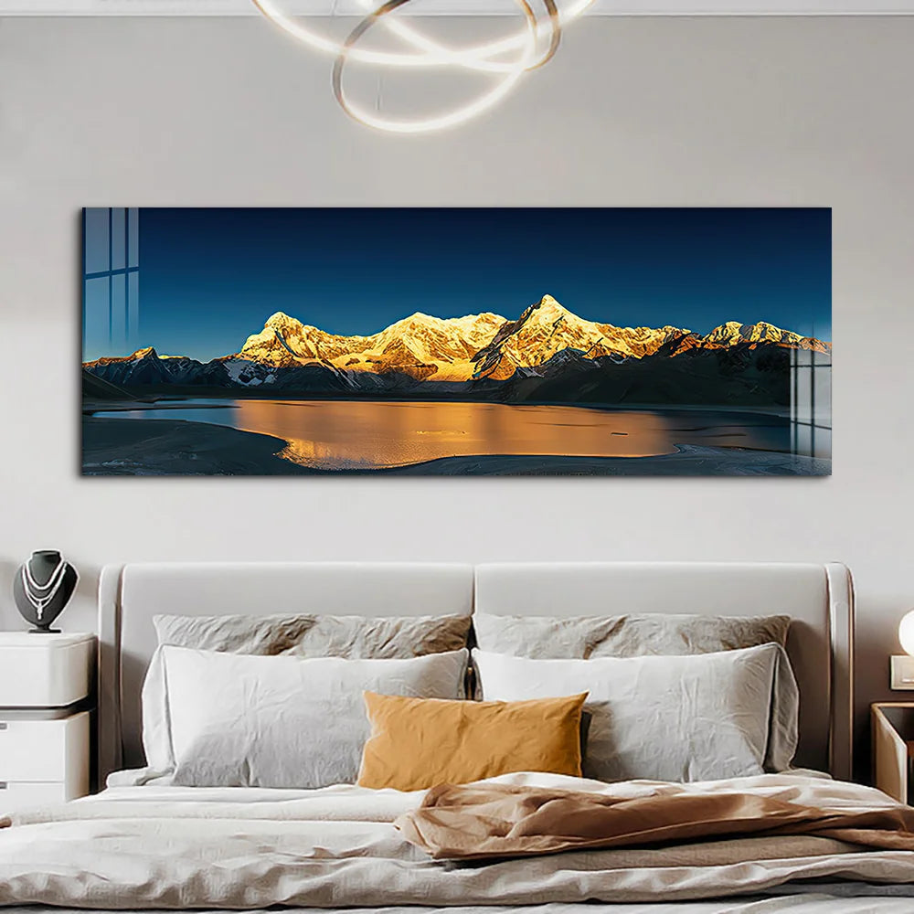 Large mountain landscape painting above a bed in a bedroom