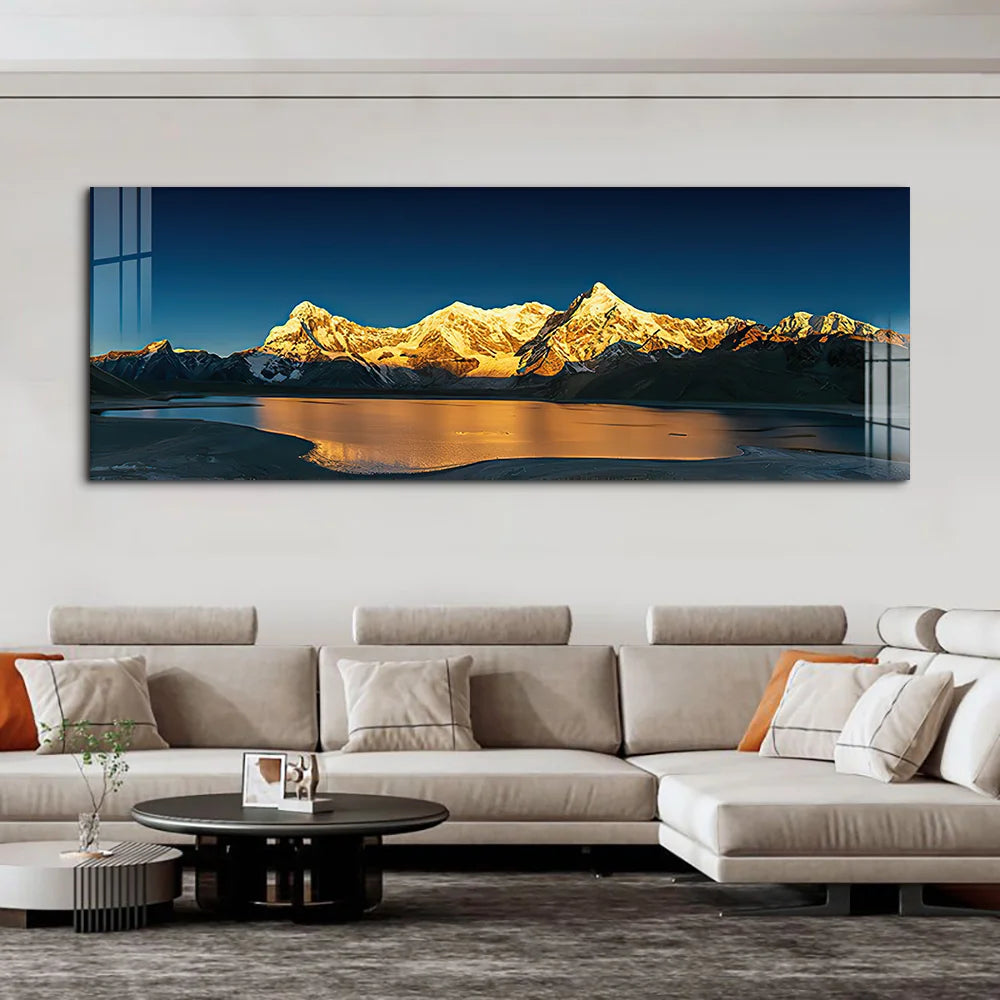 Panoramic mountain landscape painting above a modern beige sofa in a living room.