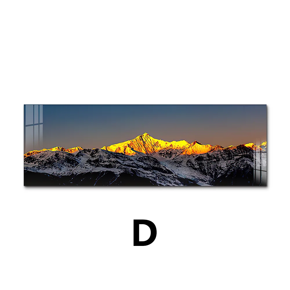 Panoramic view of a mountain range with snow at sunset, framed by black bars on a white background.