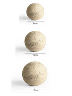 Three spherical objects of different sizes on a white background