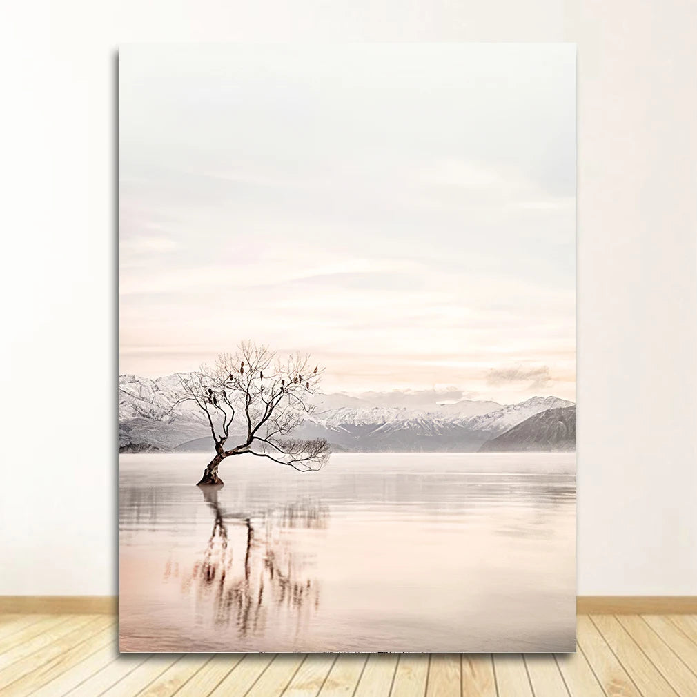 Canvas print of a tree reflected in water with mountains in the background, on a white wall.