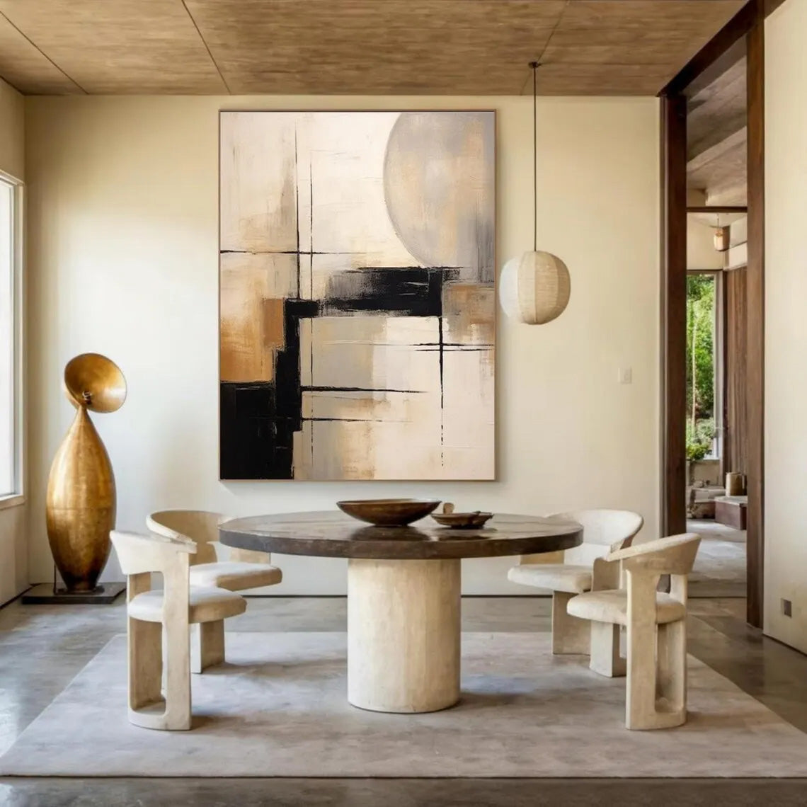 Modern dining room with a round table, chairs, and abstract art on the wall.