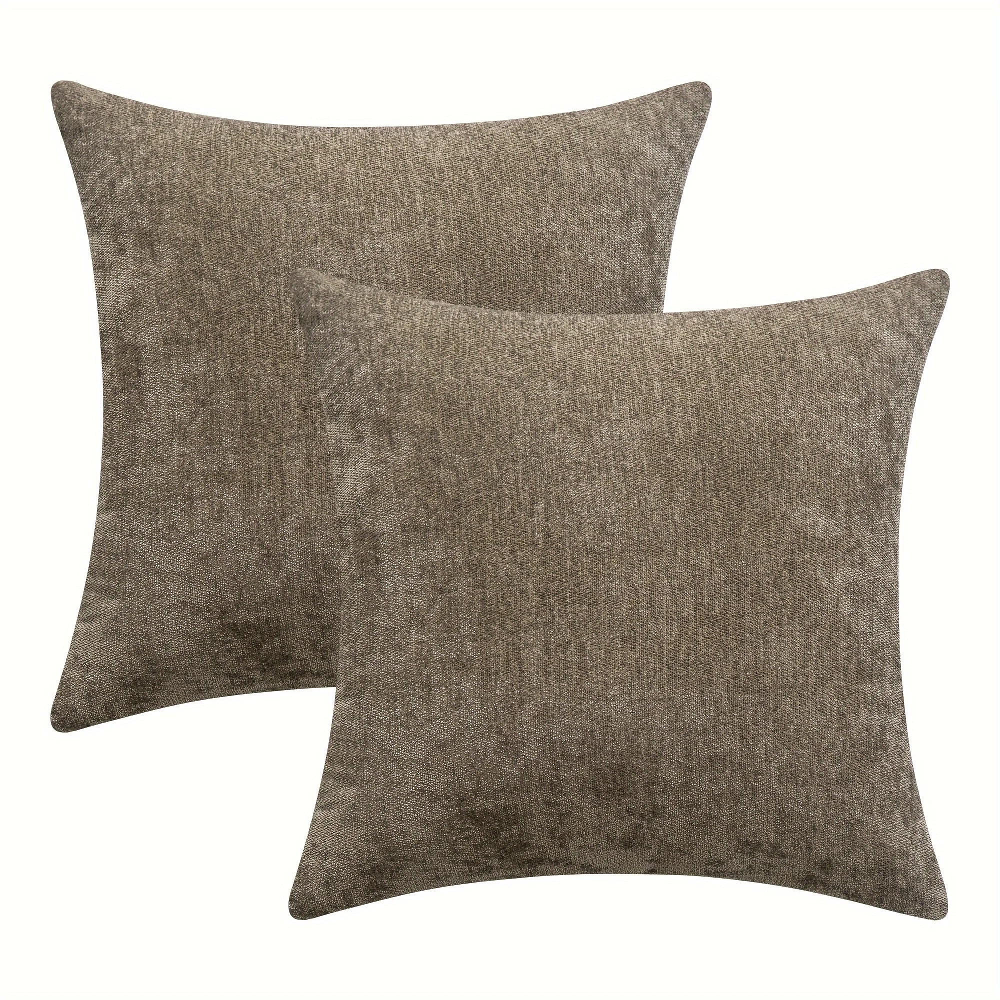 Two brown textured throw pillows on a white background