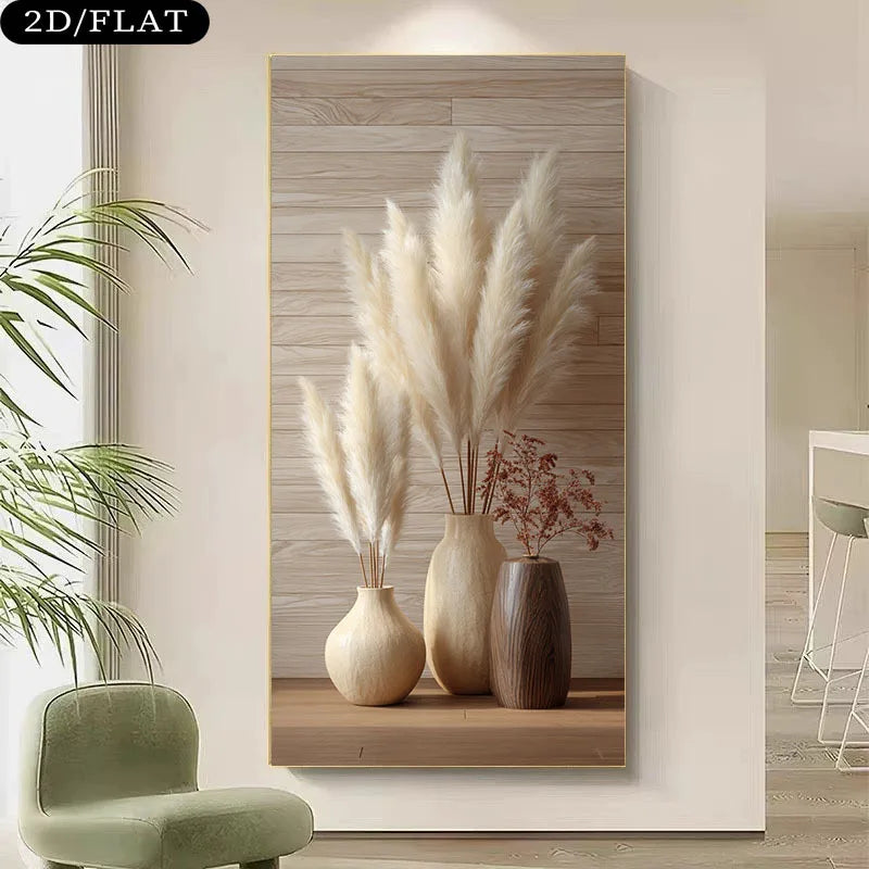 A vertical wall art print showing three beige and brown vases with pampas grass and dried flowers, displayed on a wall in a modern interior with a green chair and plant nearby.