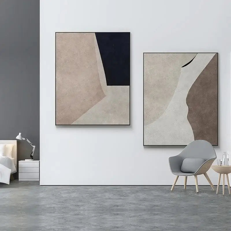 Modern interior with abstract art on a white wall, gray chair, and side table.