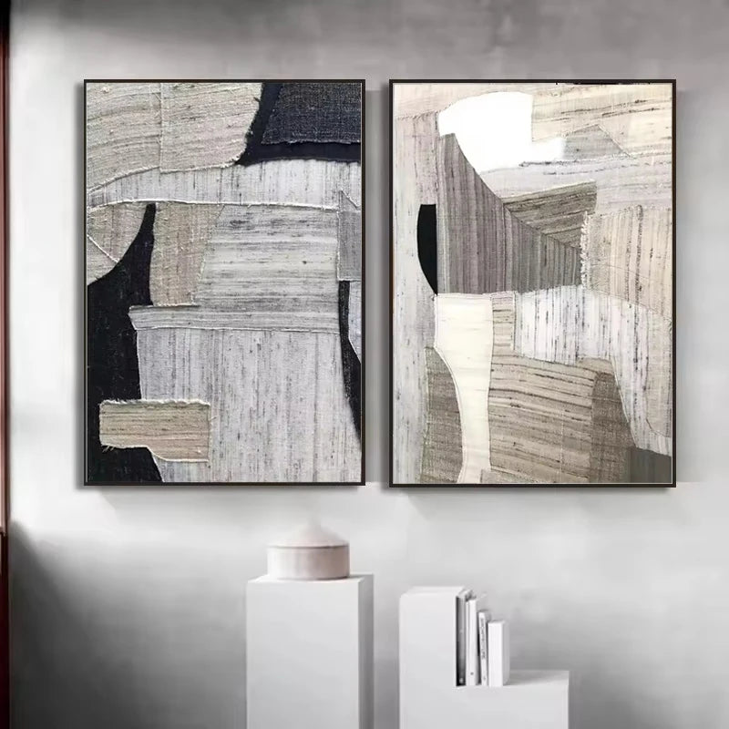 Two abstract art pieces on a wall with minimal decor.