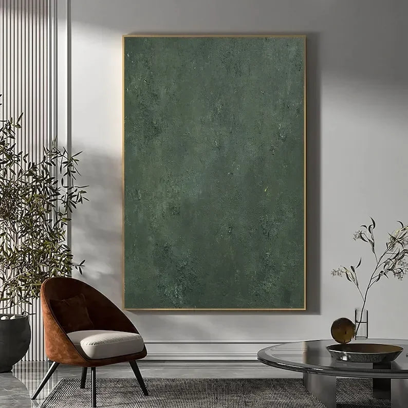 Modern living room with a large abstract green painting on the wall, a brown chair, and a glass coffee table.