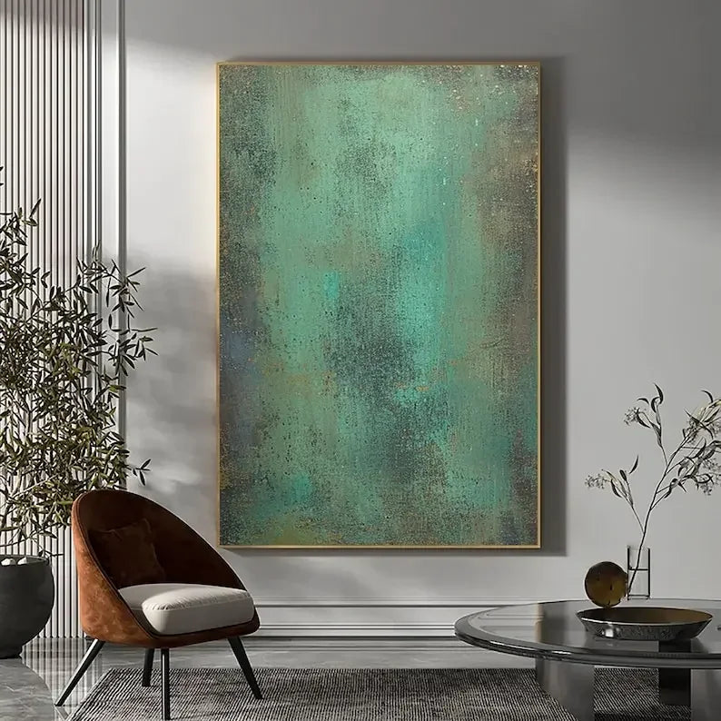 Abstract painting on a wall in a modern living room with a brown chair and decorative elements.